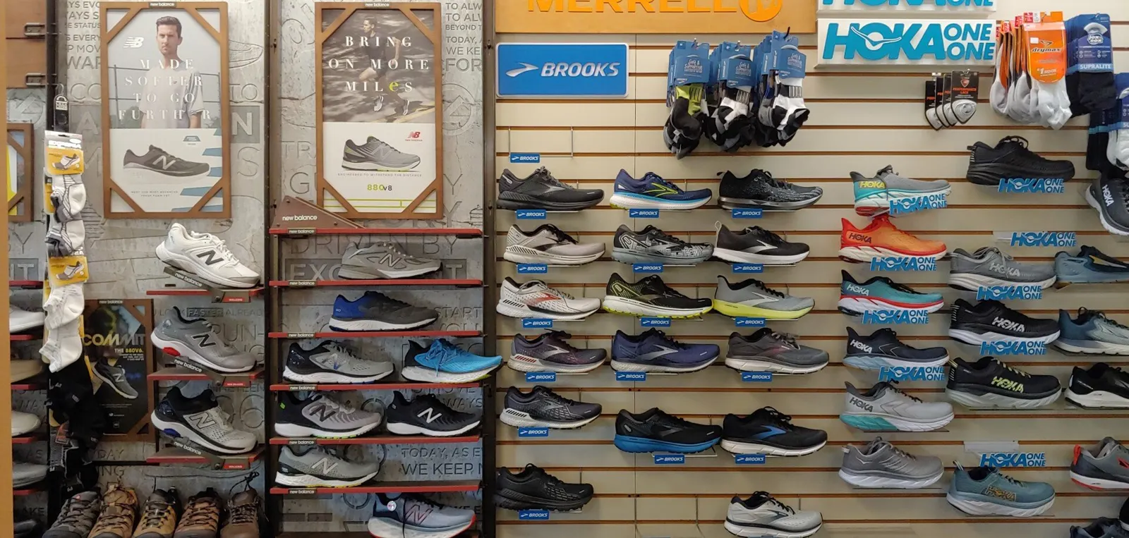 Wall of Brooks and Hoka running shoes
